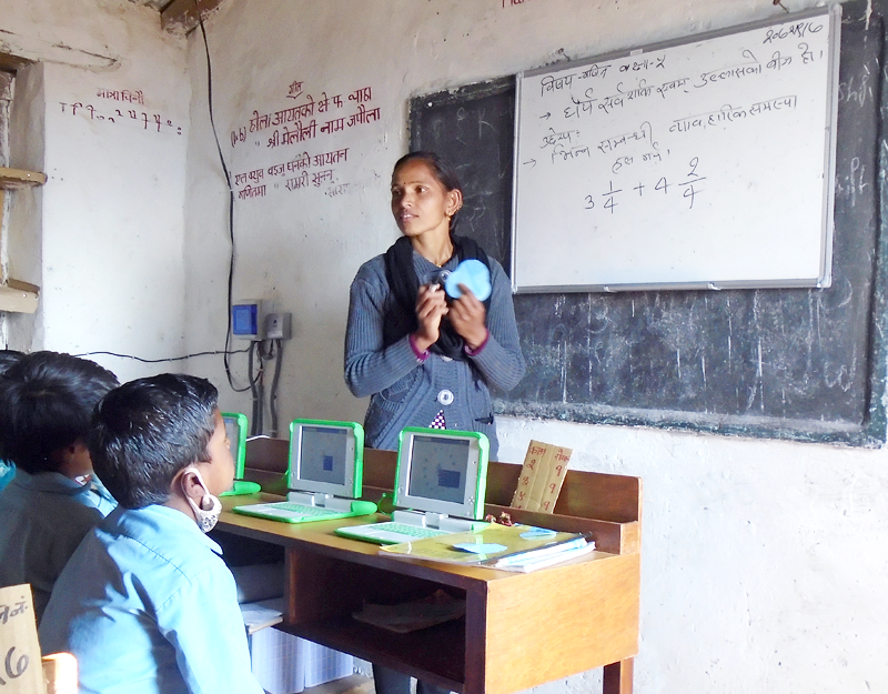 Indra Pokharel explaining the concept of addition of fractions to Grade 5 students, before they start activities on laptops, in December 2016.