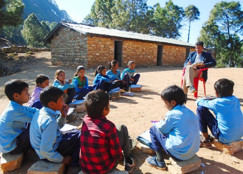 Children attending class outside.